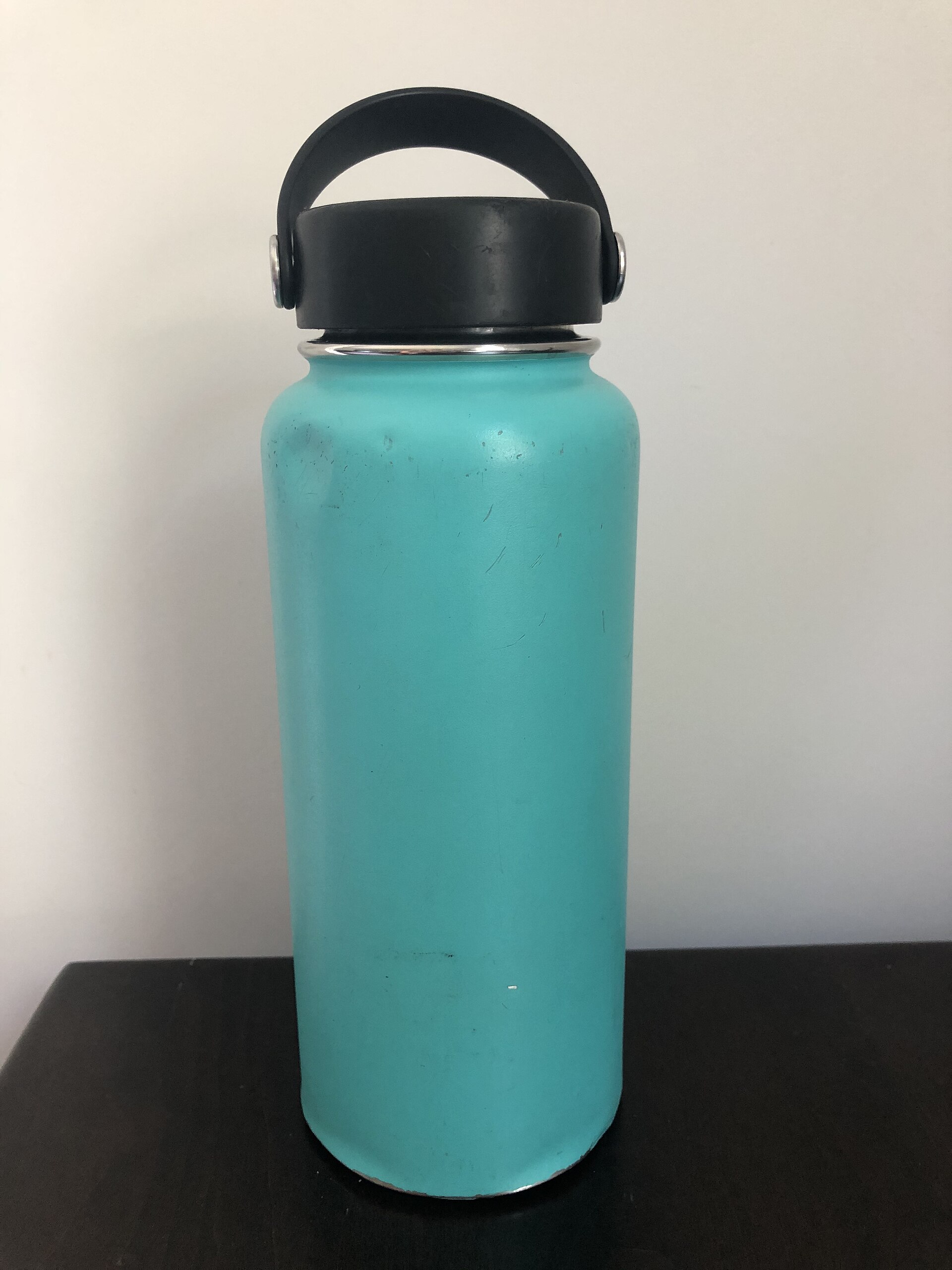 A wide-mouth bottle in sea green with a loop lid