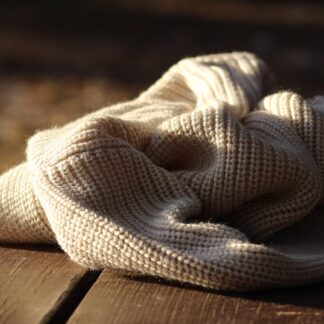 A folded cream waffle-knit crew jumper